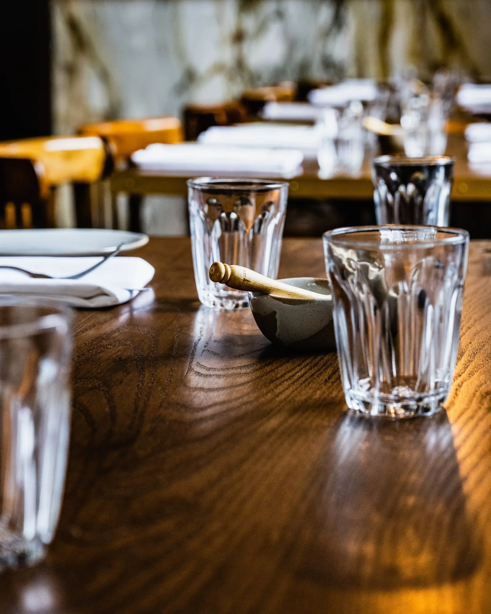 Brass-edged Oak tabletop with glassware, up close