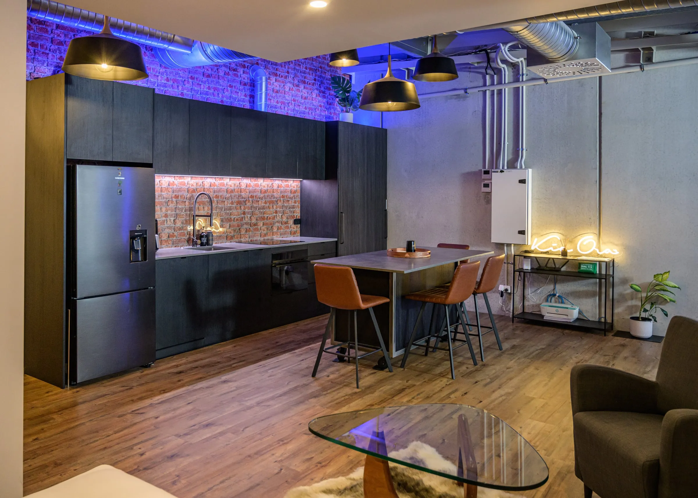Black Oak kitchen with recycled brick splashback, island and pendants