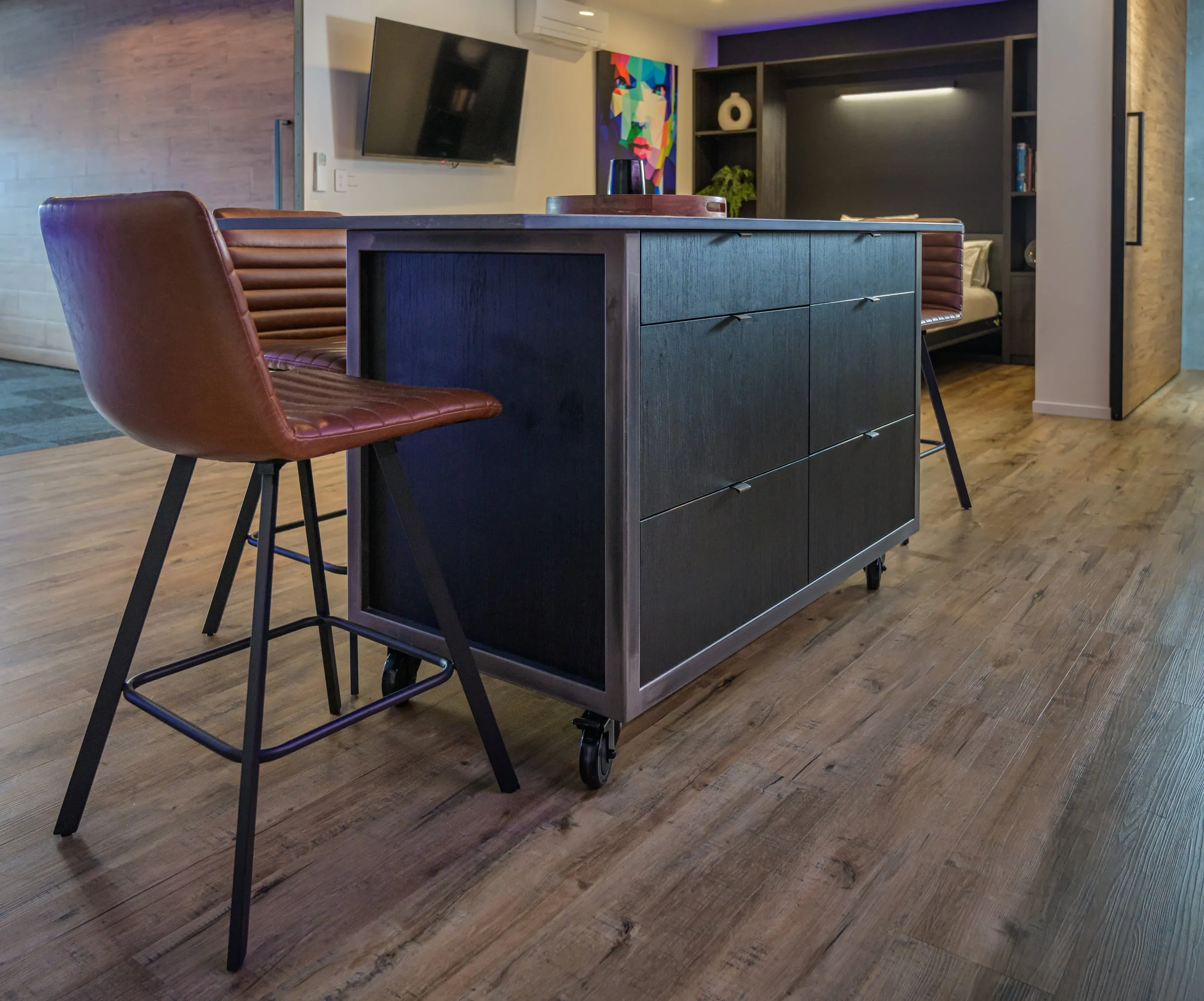 Castored island with raw steel frame and black Oak drawers
