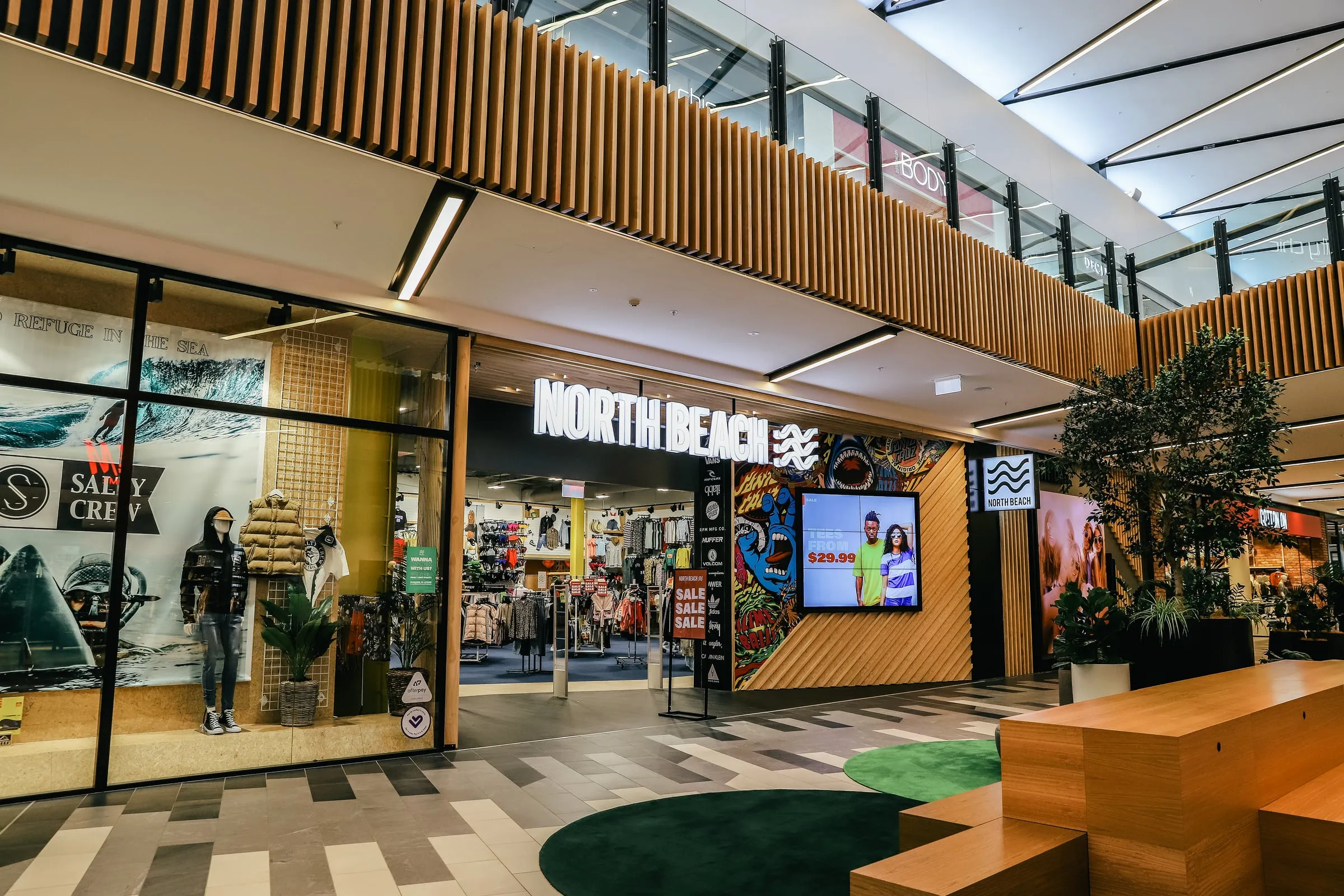 Wide atrium elevation with Cedar batten balustrade band and shopfront