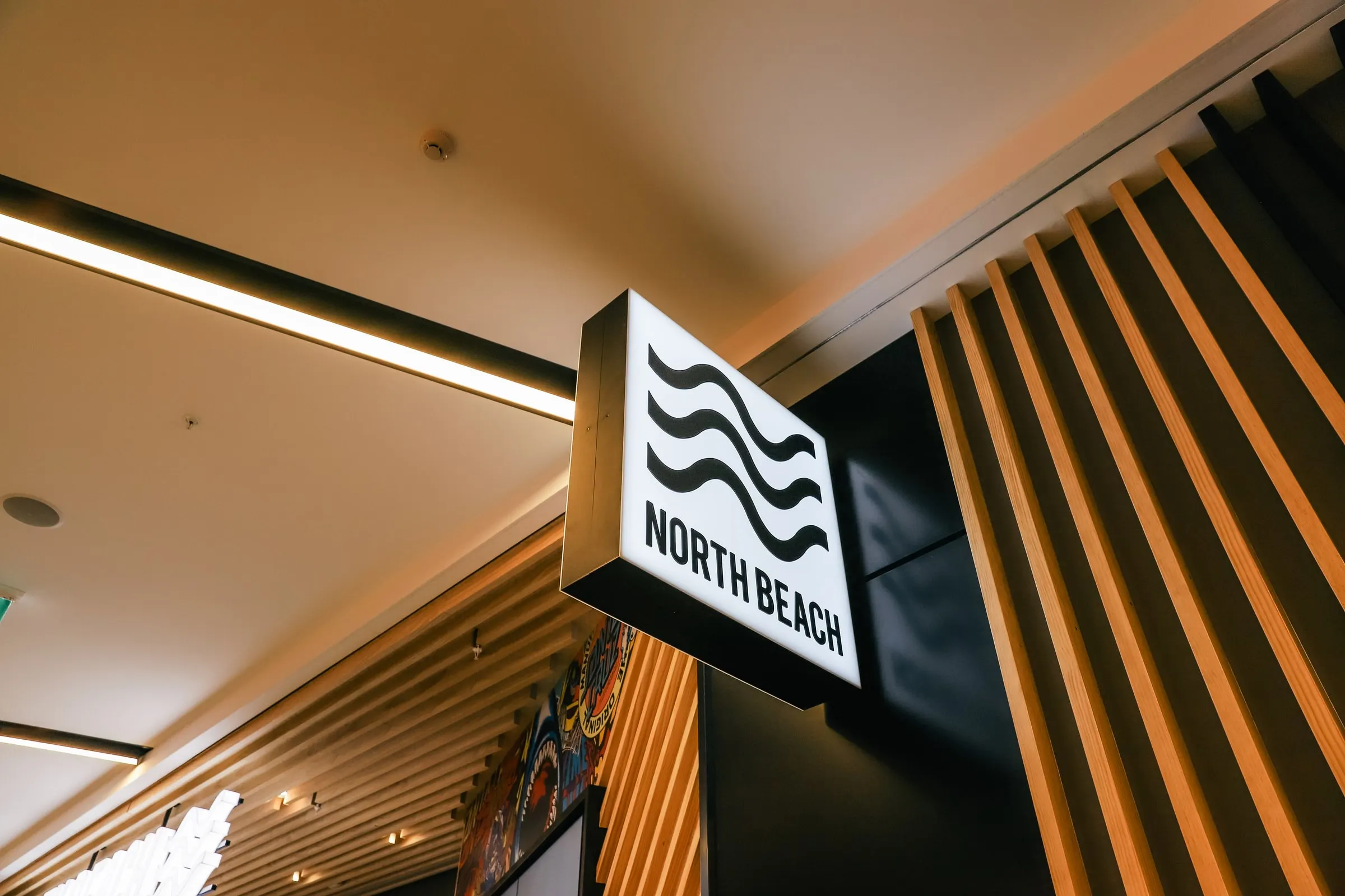 Douglas Fir fin wall with black steel lightbox signage, North Beach, Tauranga Crossing