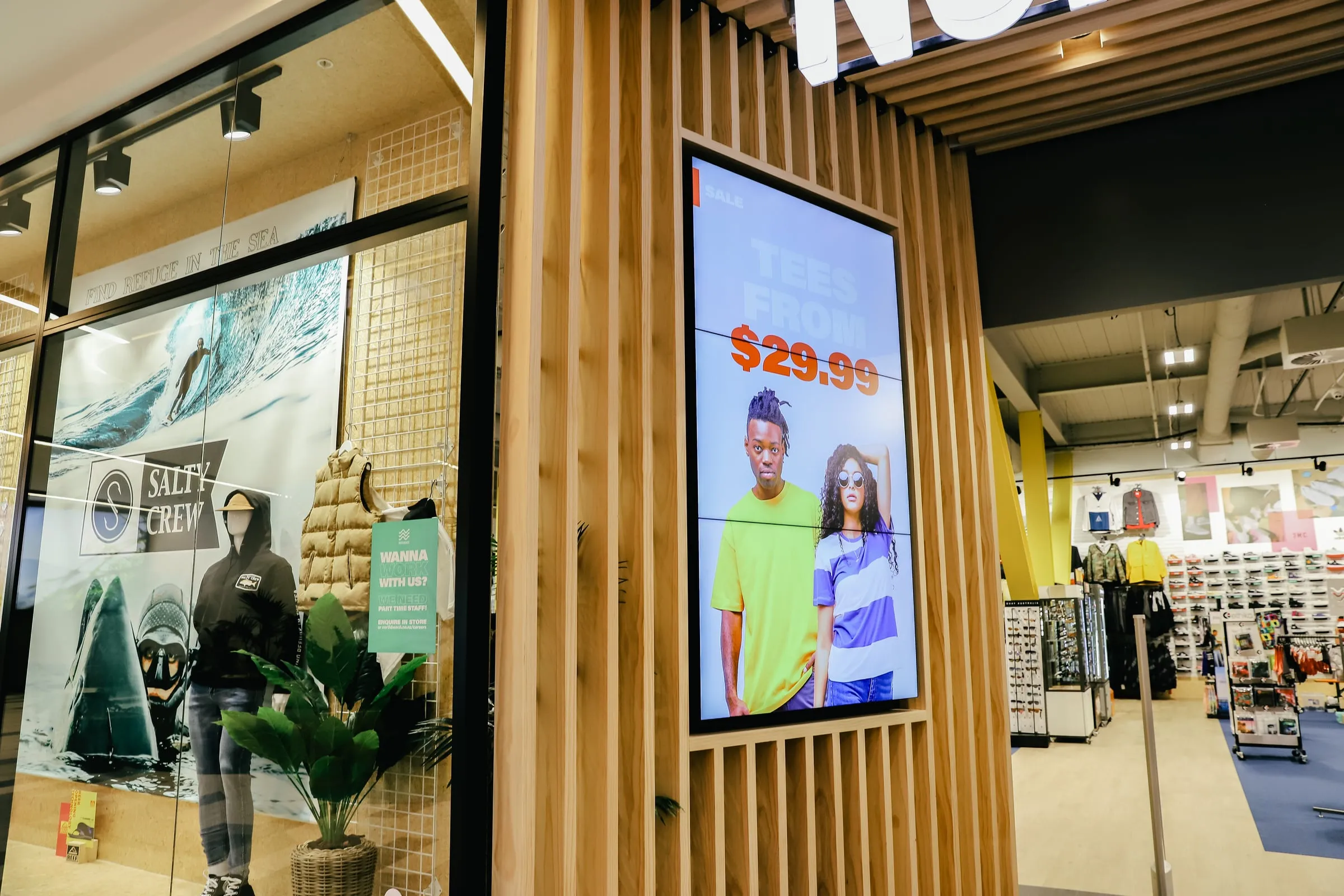 Digital screen recessed flush into a vertical Cedar slat blade