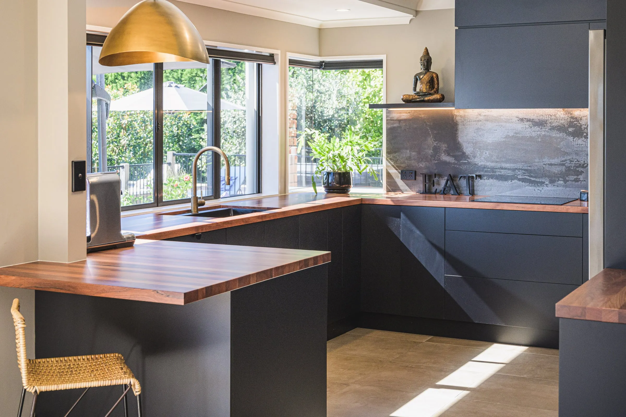 Charcoal handle-less kitchen with Jarrah breakfast bar and brass dome pendant