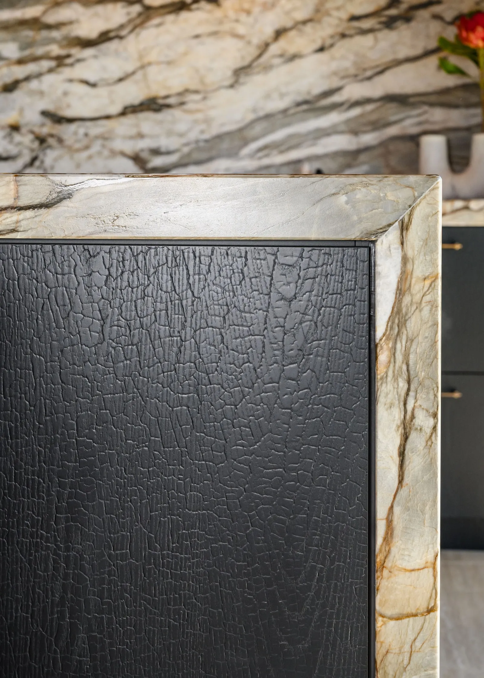 Charred Oak door meeting a mitred Quartzite frame, close up