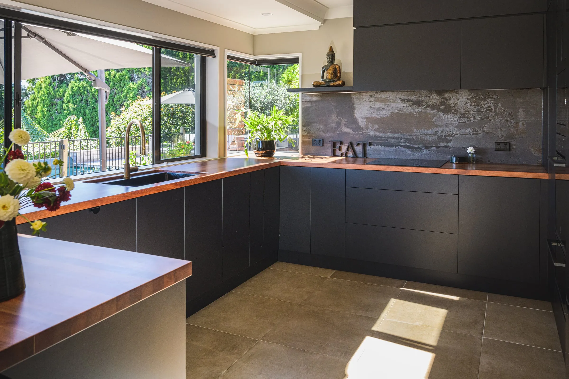 Sunlit three-quarter wide showing both benchtop runs and corner window