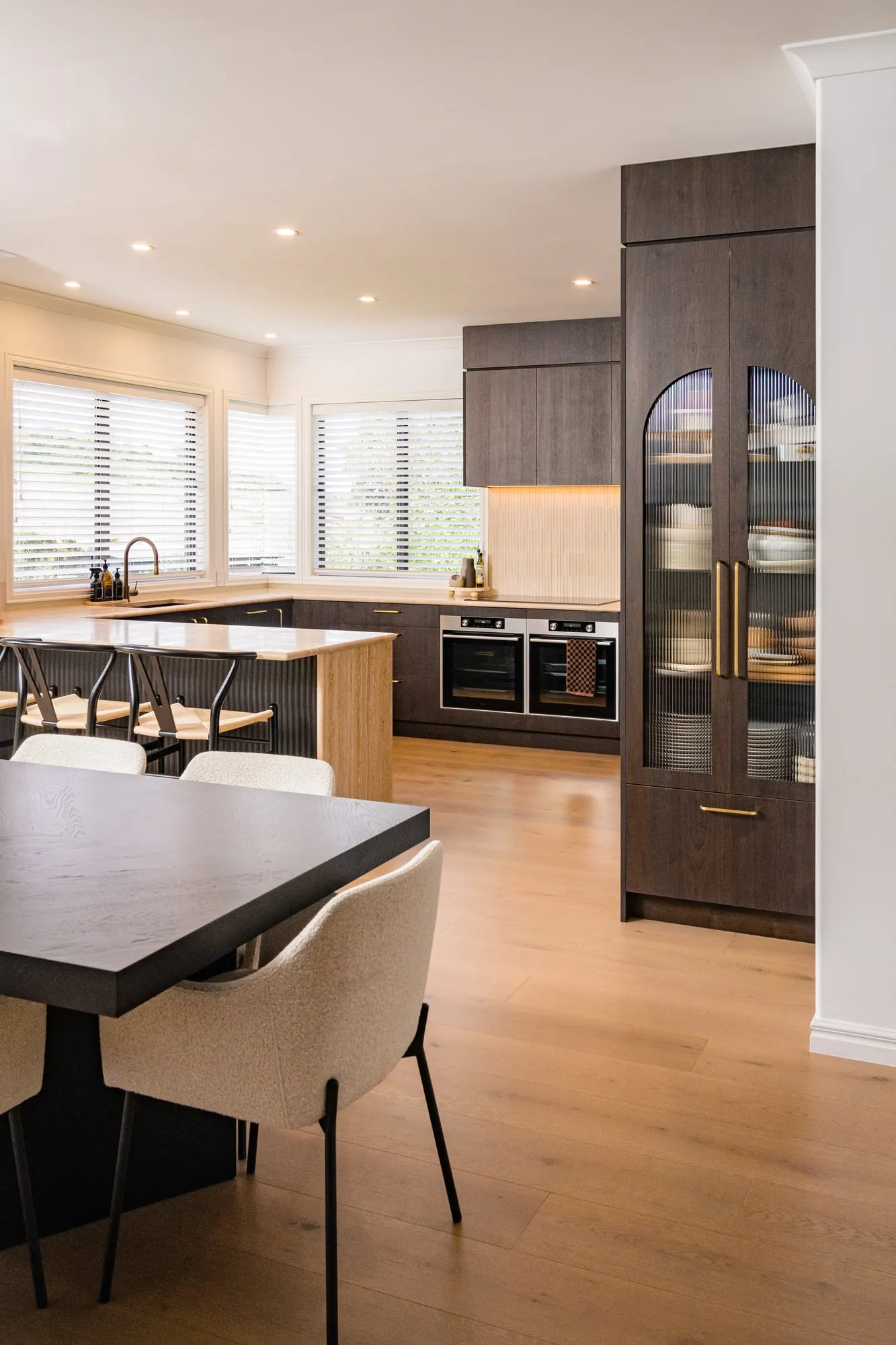 Tall view across the dining table into the Walnut kitchen