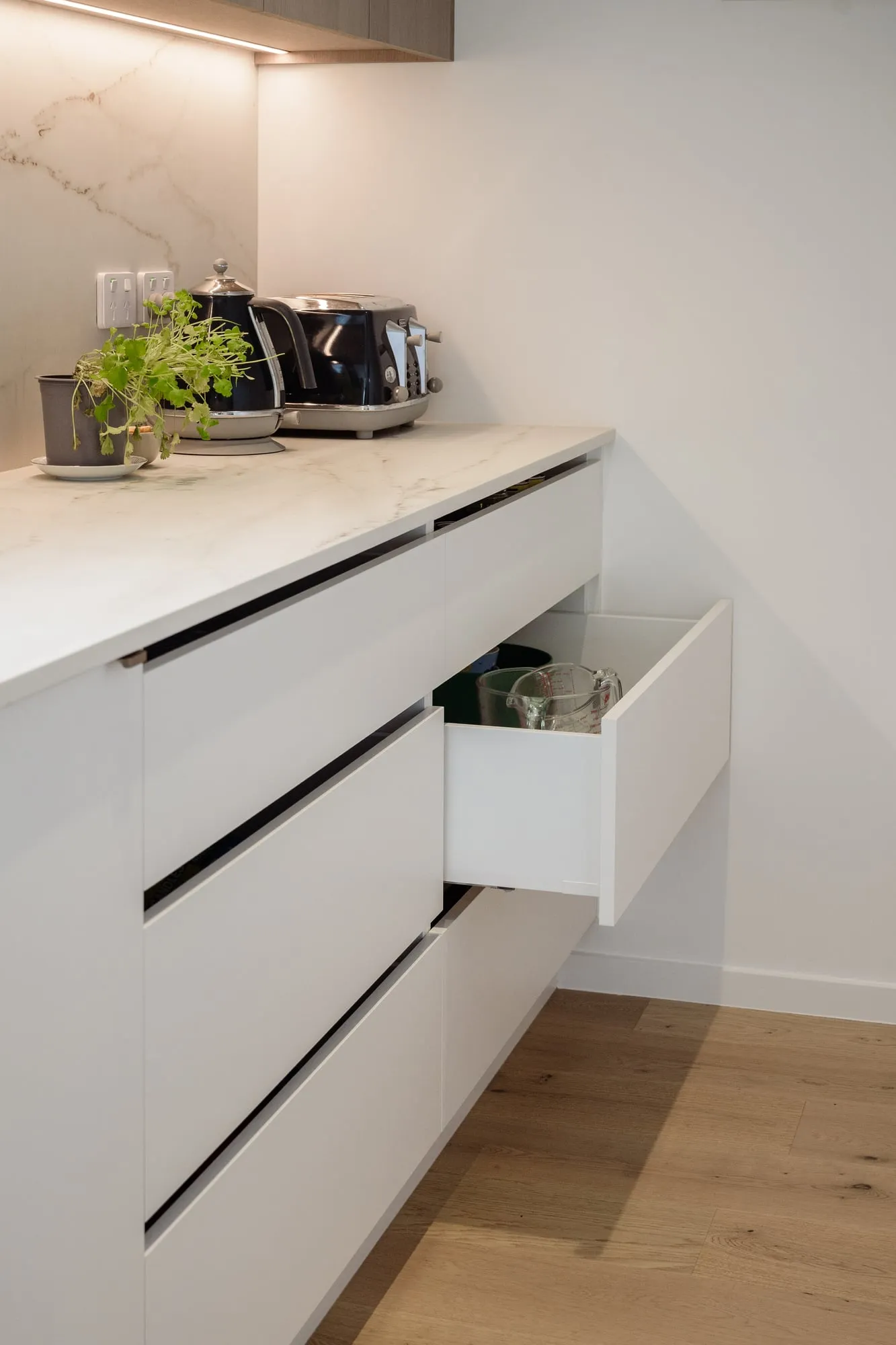 Open drawer bank showing negative-detail pulls and soft-close runners