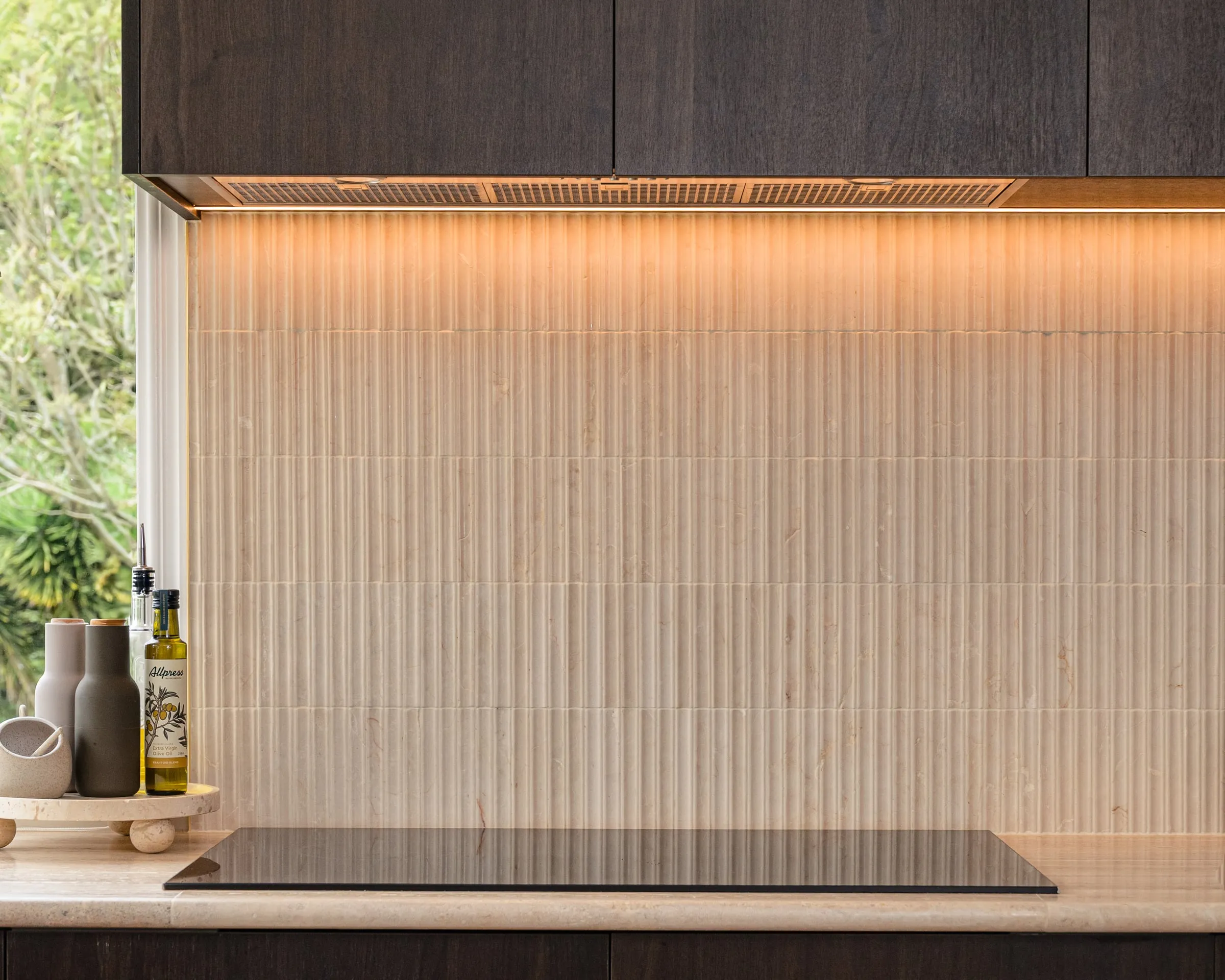 Fluted bone kit-kat tile splashback under a warm light line