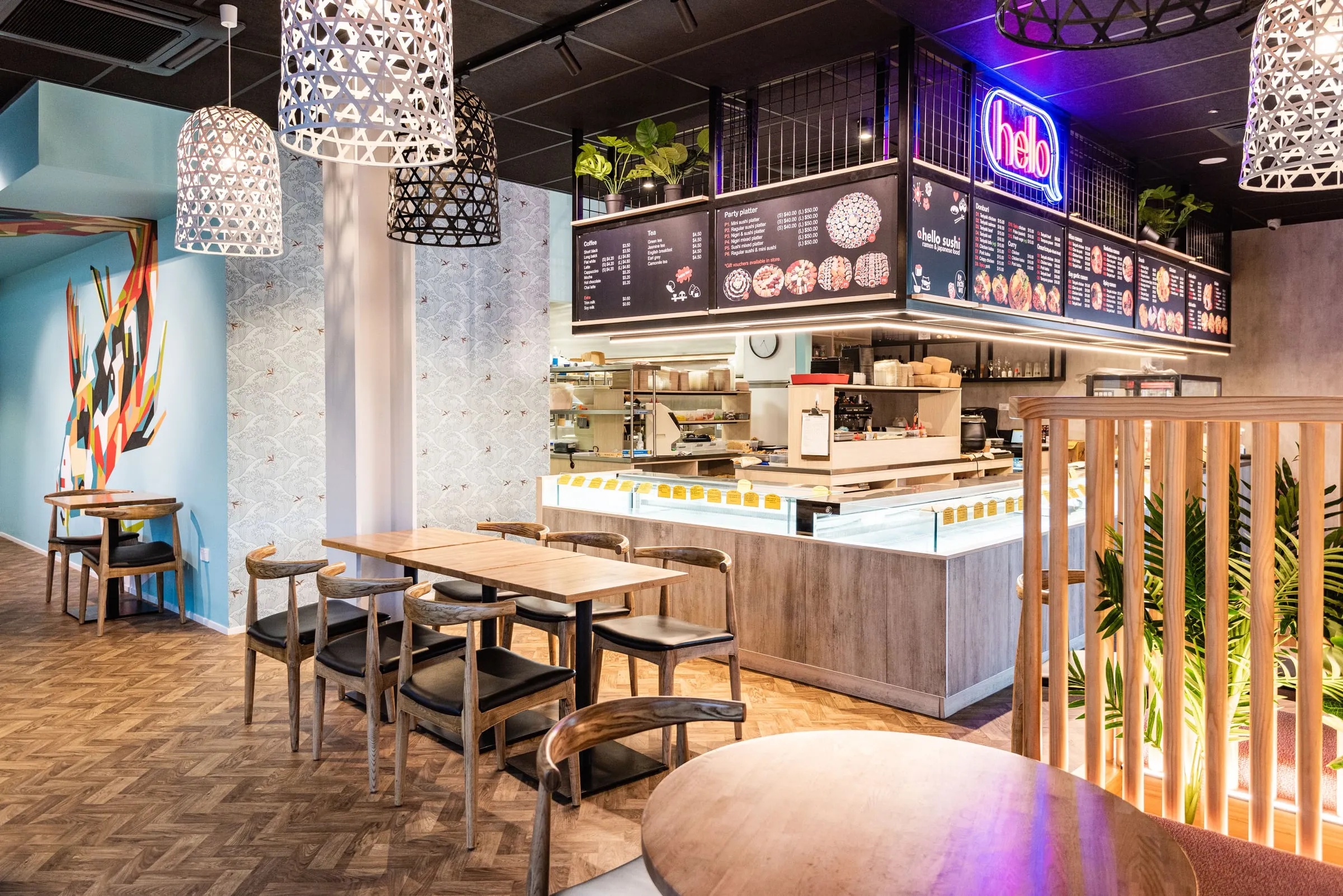 Hello Sushi dining room with wave wallpaper, cane lanterns and sushi counter