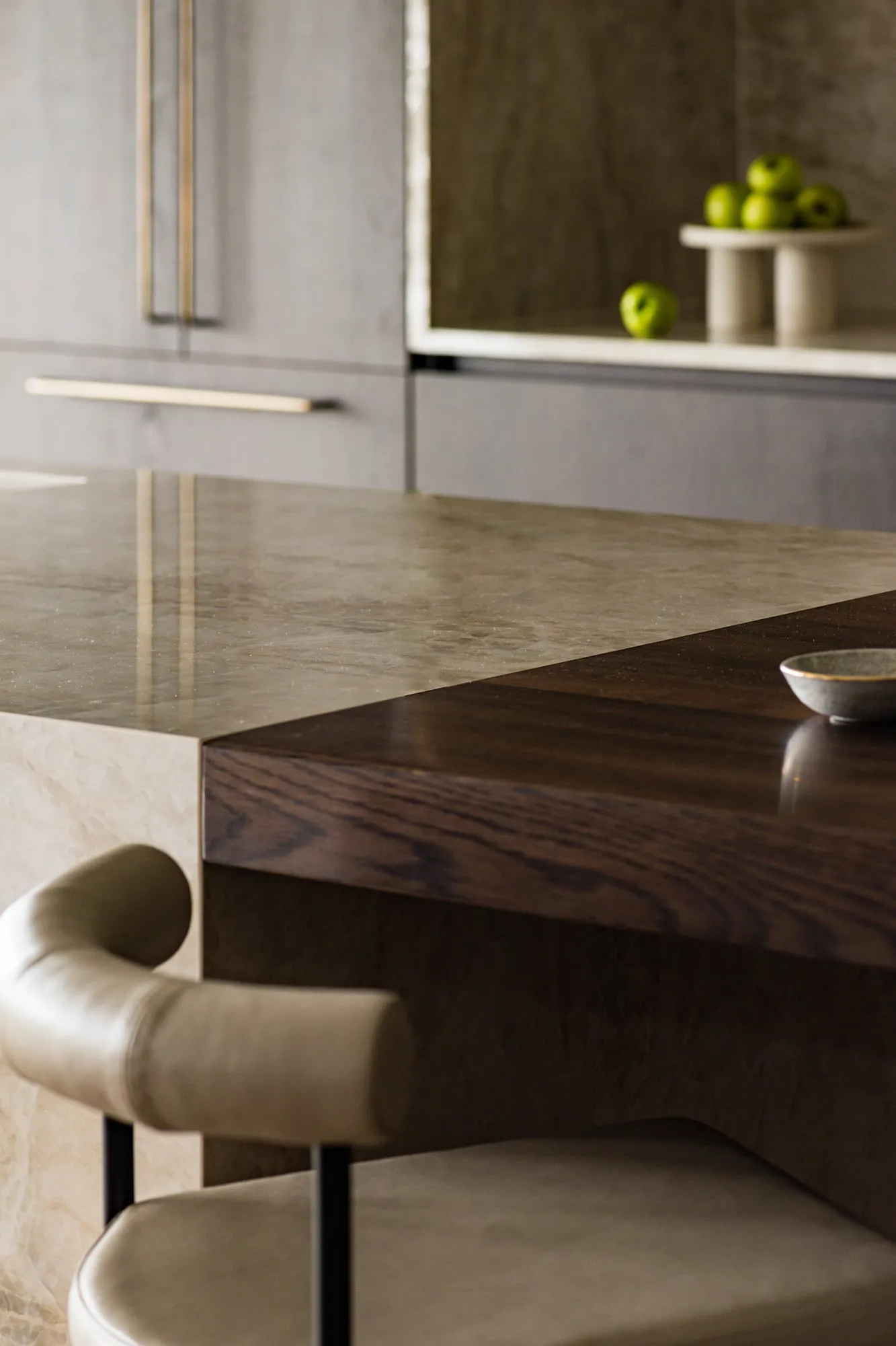 Mitred quartzite benchtop meeting dark oak breakfast ledge, close up