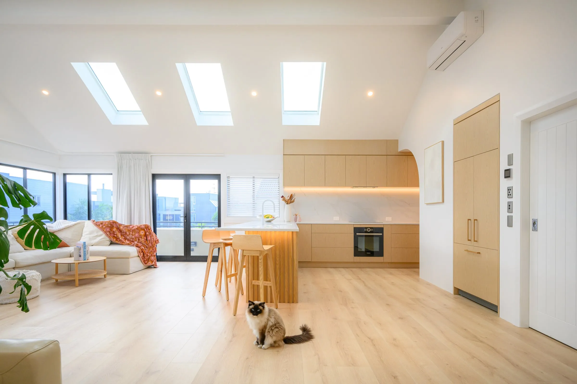 Full room from the living side, skylights and balcony doors