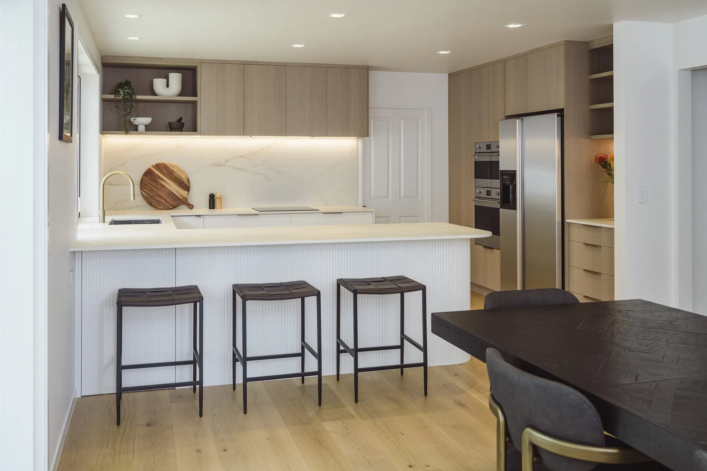 Limed Oak appliance wall and curved island from the opposite axis
