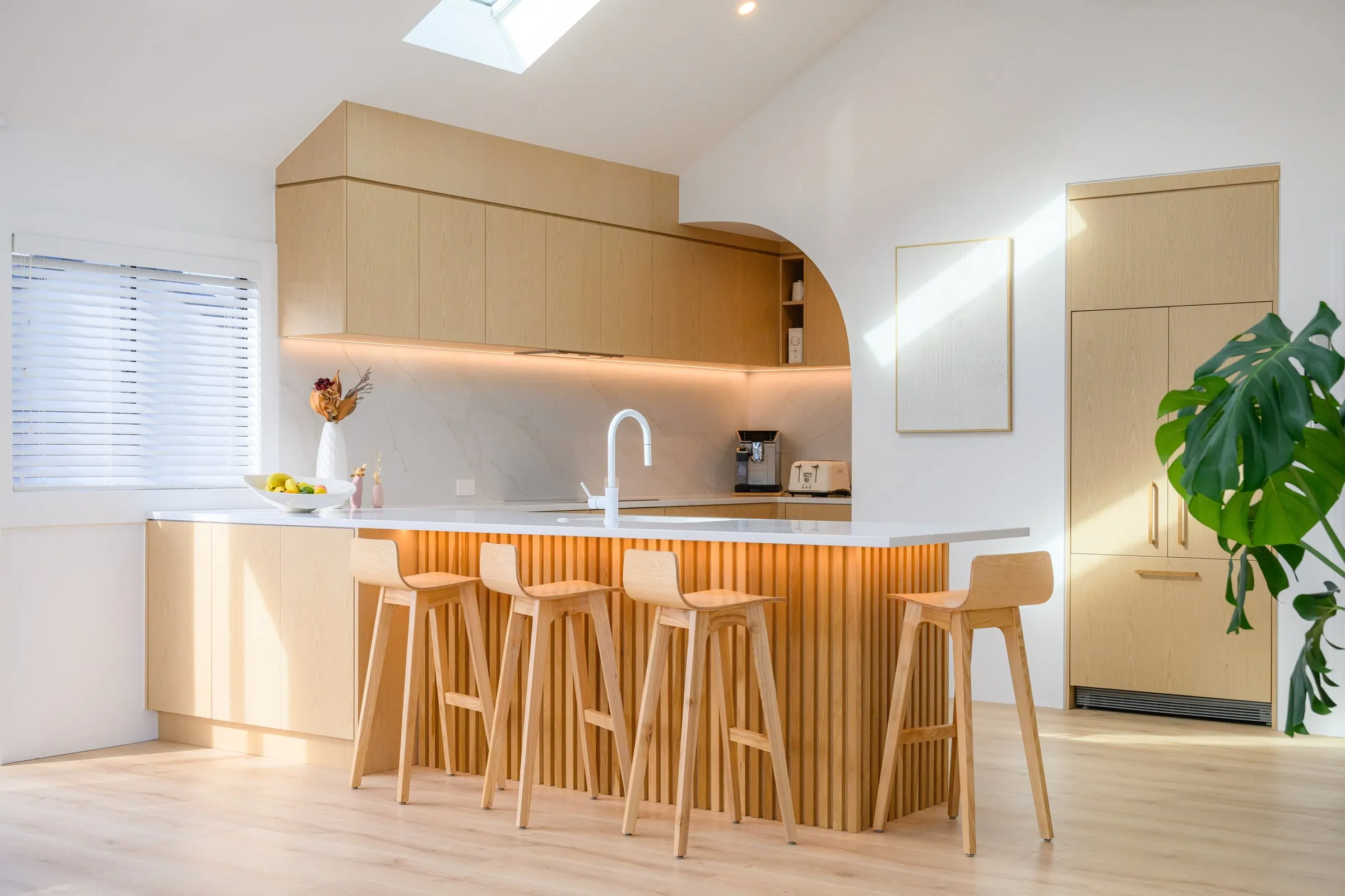 Pale Ash kitchen with fluted island, arch and skylight