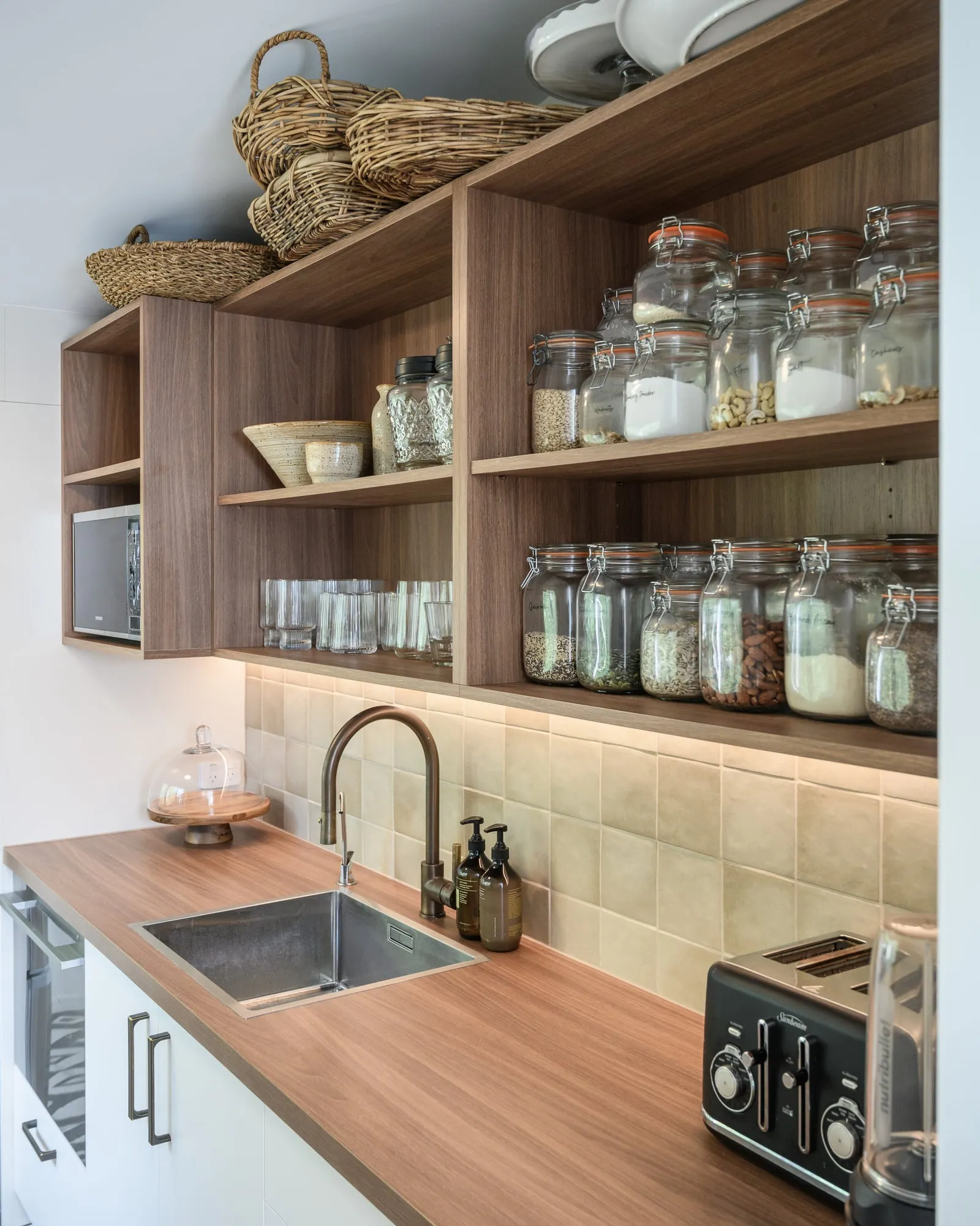 Scullery with open Walnut shelving, glass storage jars and a timber benchtop