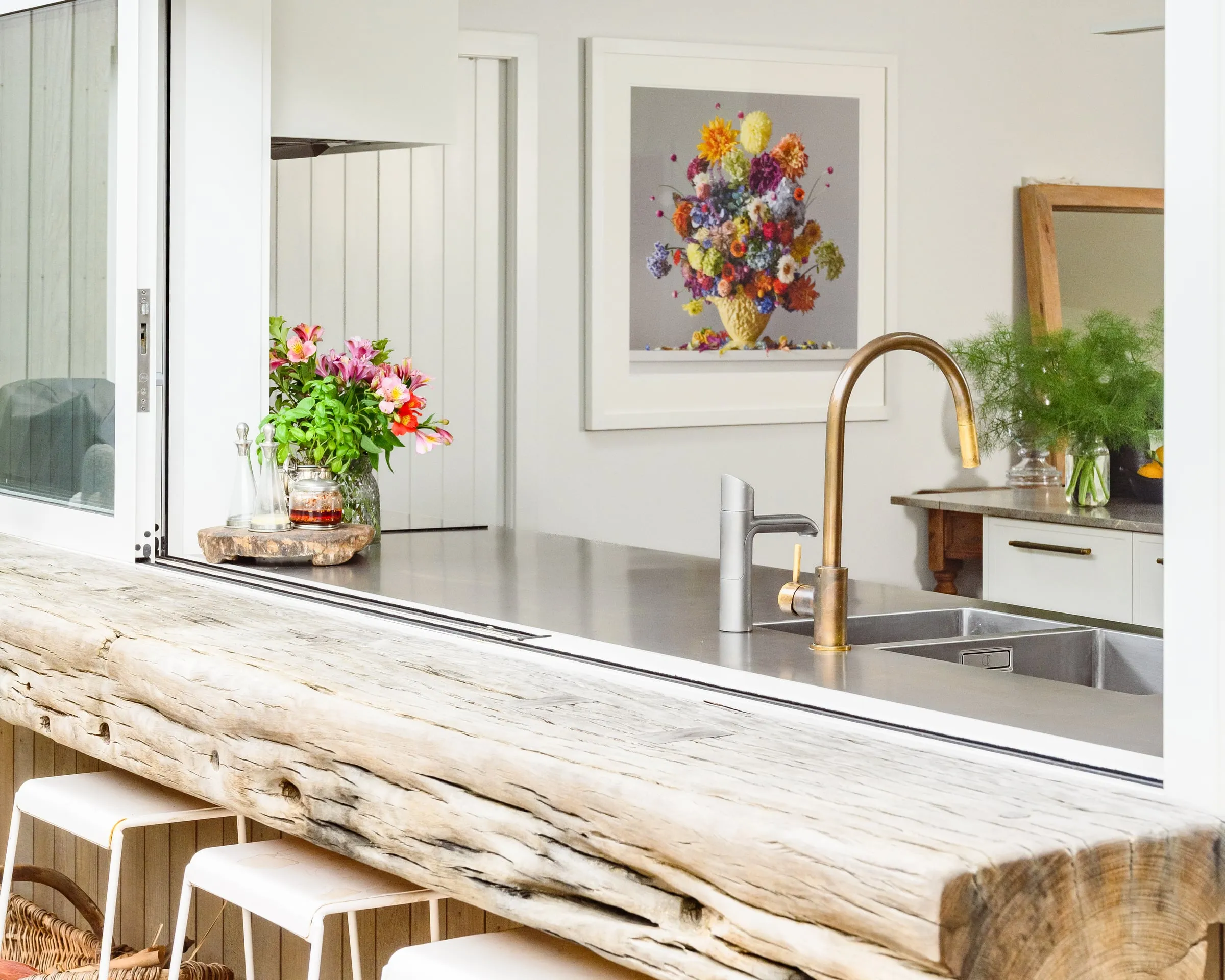 Servery window with recycled-timber beam ledge and brass tap