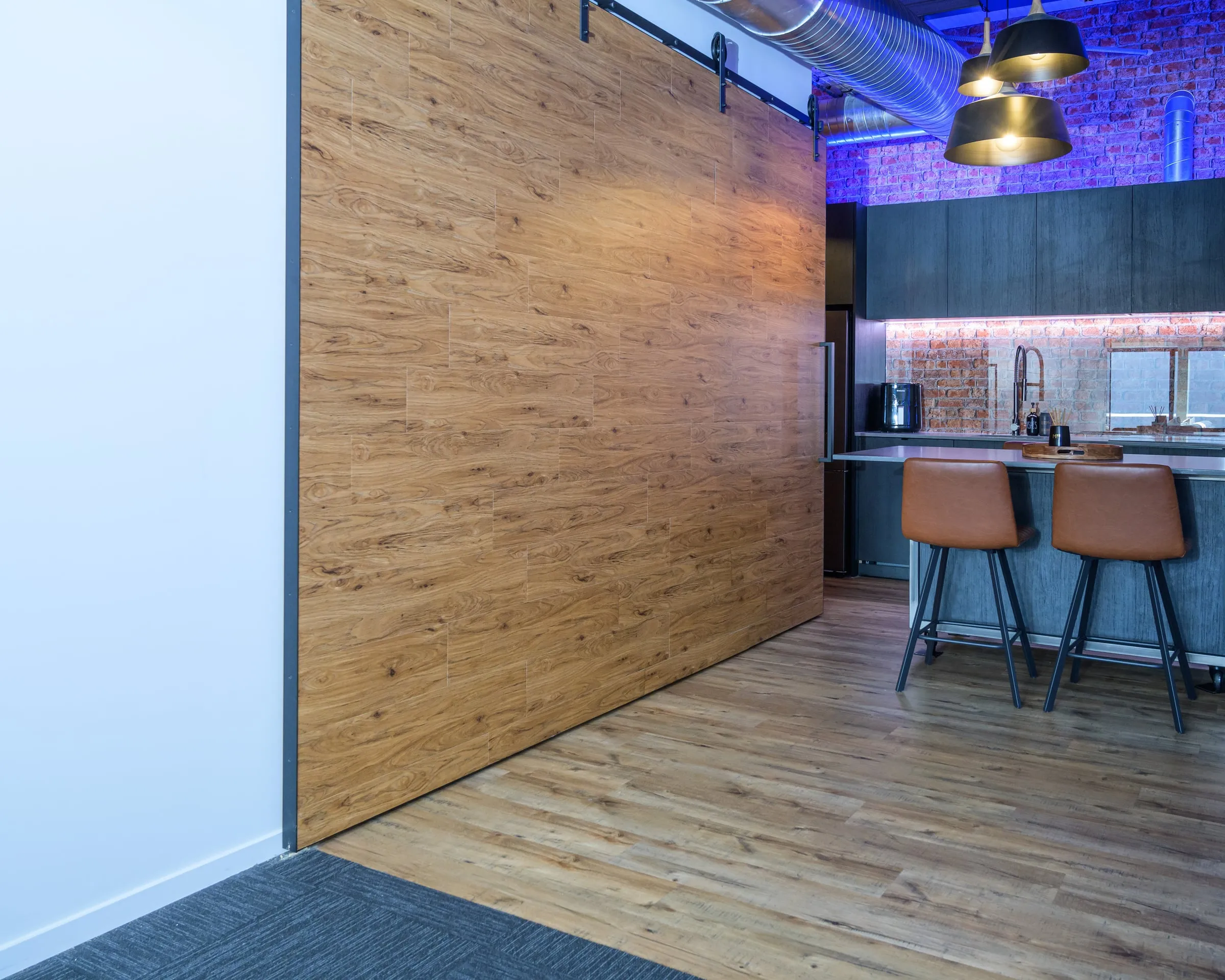 Sliding timber panel wall as one plane, kitchen beyond