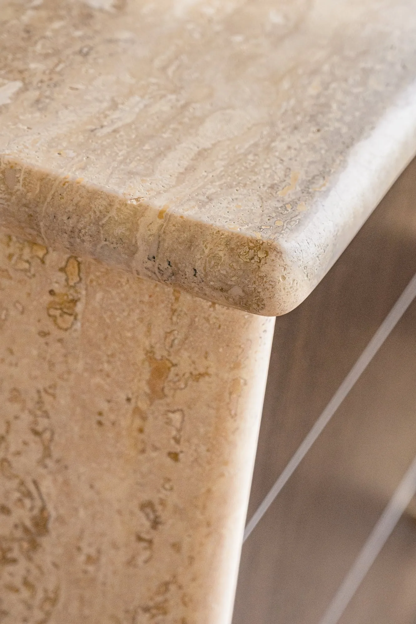 Close-up of unfilled Travertine and its rounded bullnose edge
