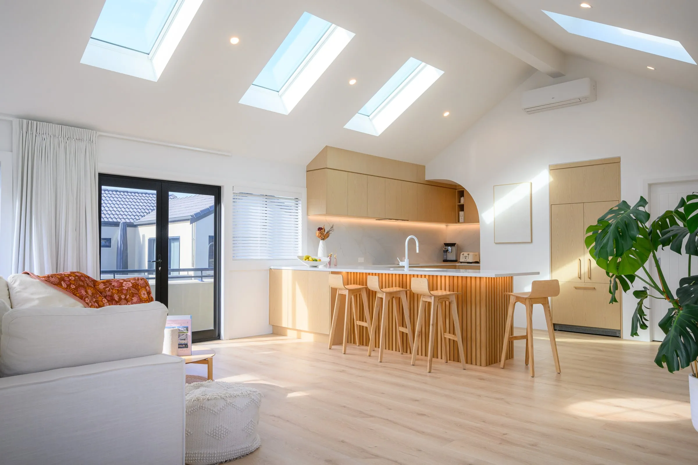 Vaulted ceiling with three skylights over kitchen and living room