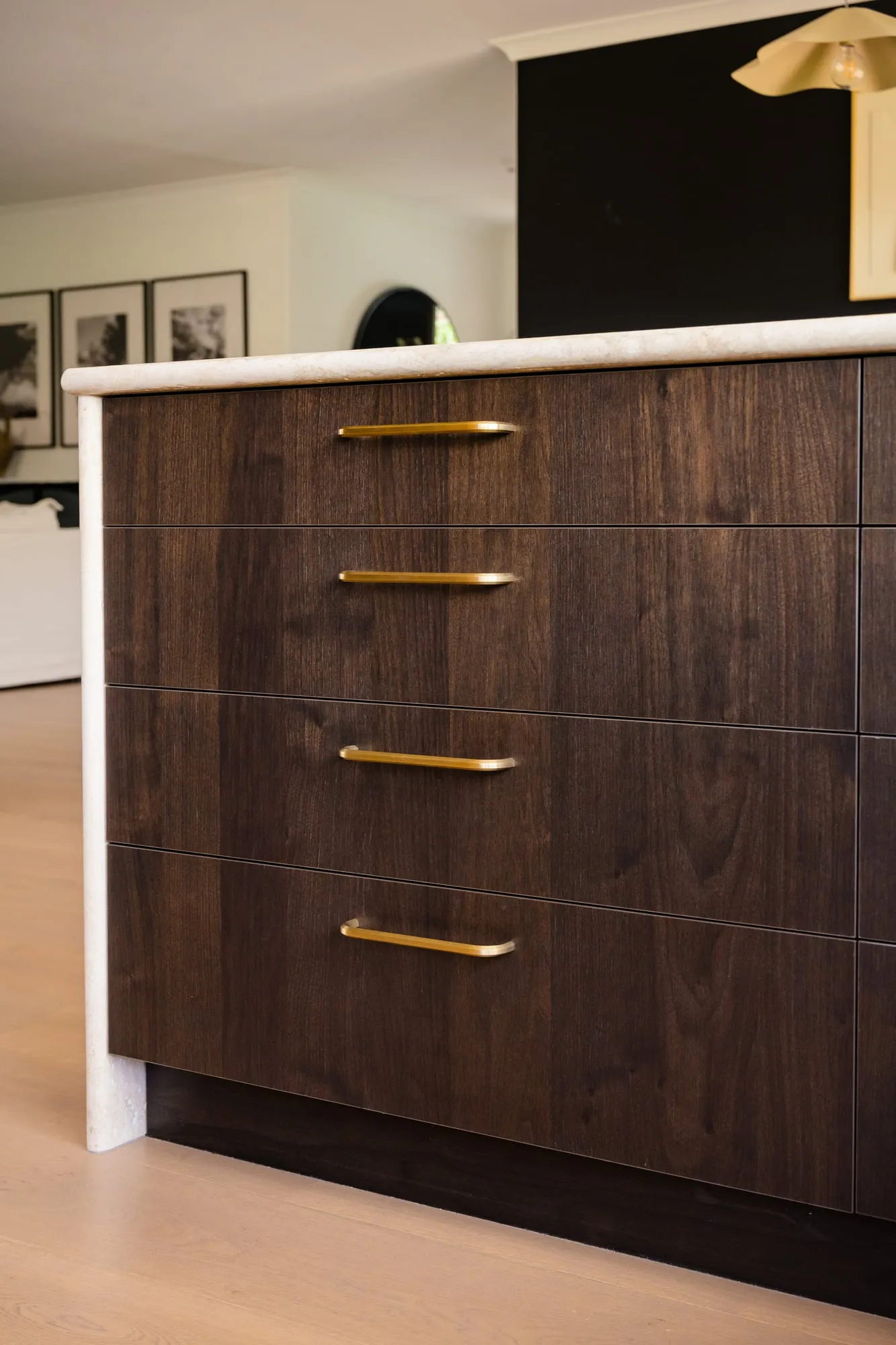 Book-matched Walnut drawers, brass pulls and Travertine waterfall edge