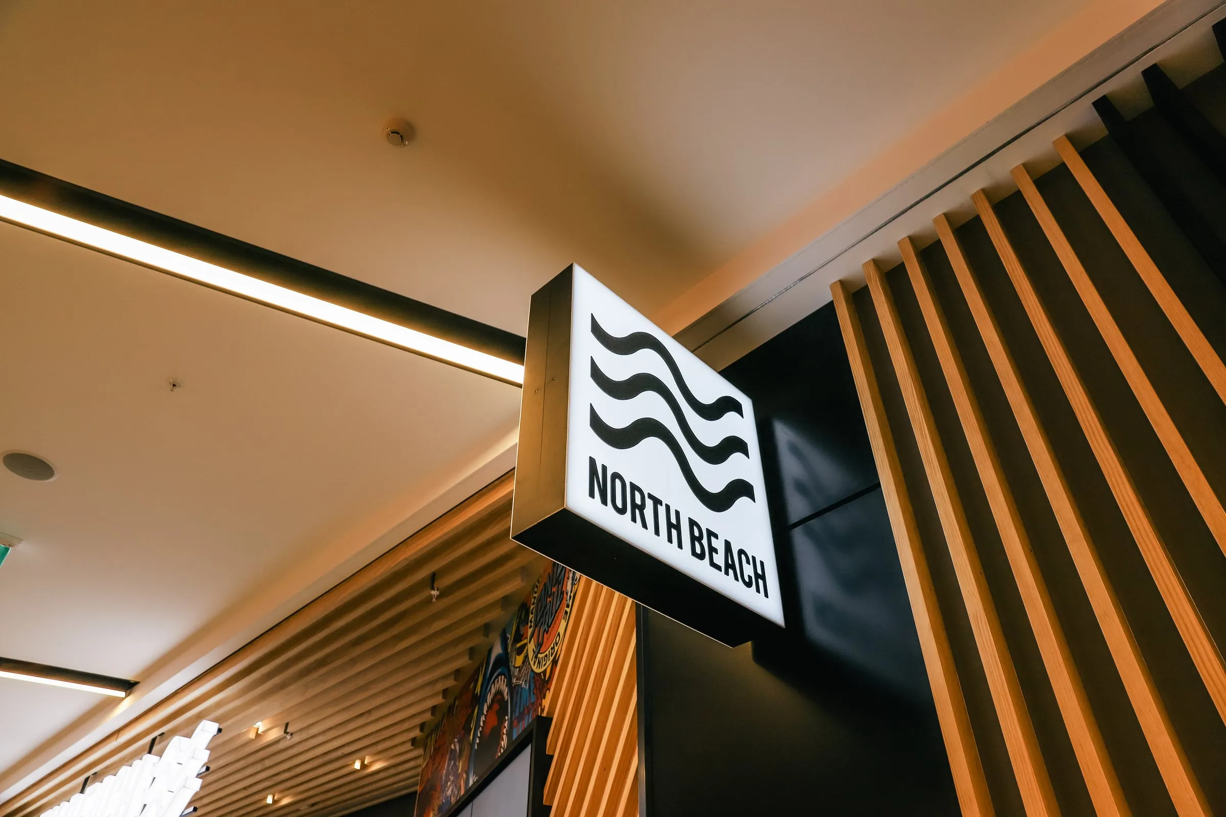 Wayfinding lightbox against the Douglas Fir fin wall