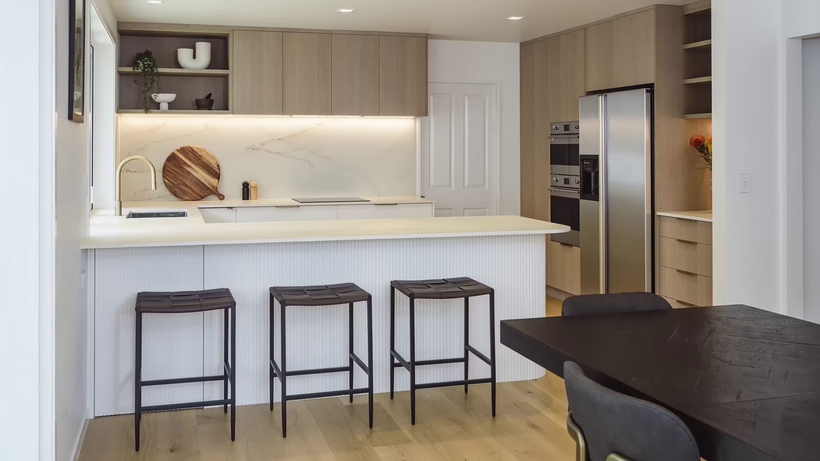 The finished Valley Road kitchen — fluted island, limed oak, brass tapware